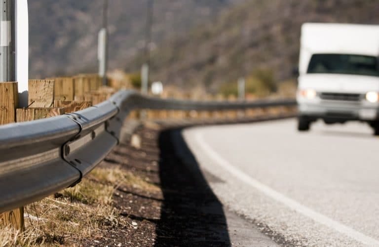 Metal highway guardrail on a winding road with a white truck approaching, illustrating the concept of statistical control versus intellectual control in software testing. Metal highway guardrail on a winding road with a white truck approaching, illustrating the concept of statistical control versus intellectual control in software testing.