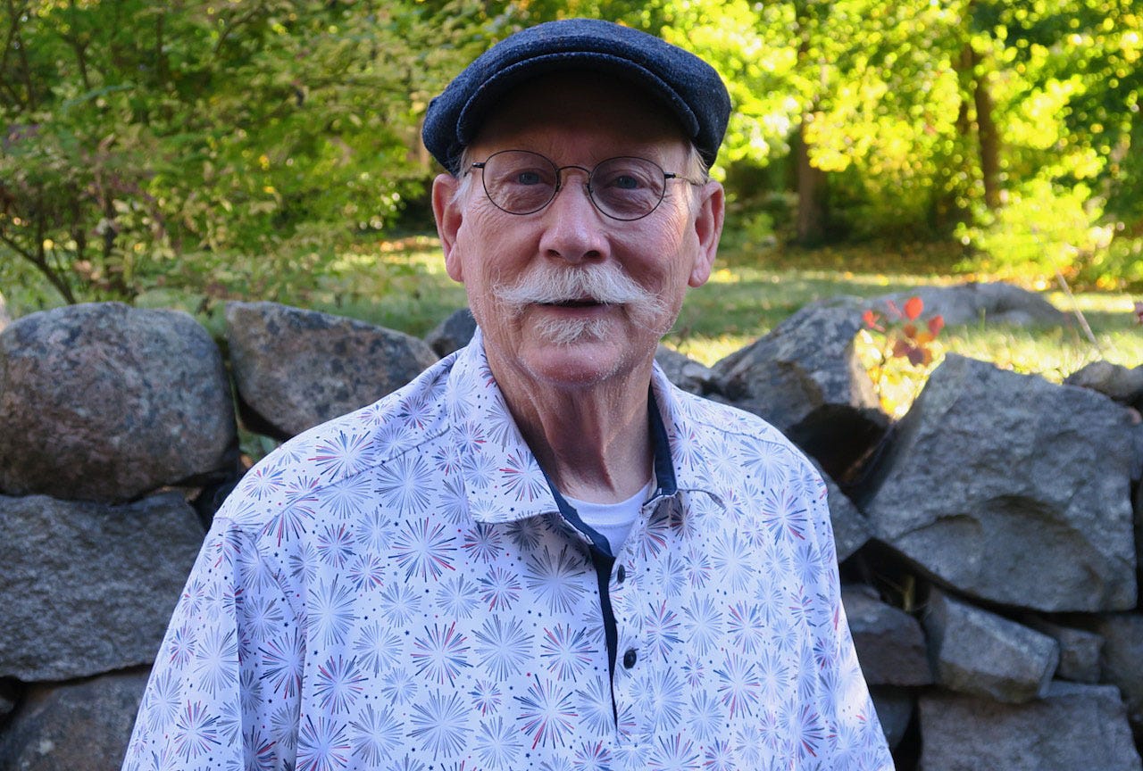 A person with a mustache and hat

Description automatically generated