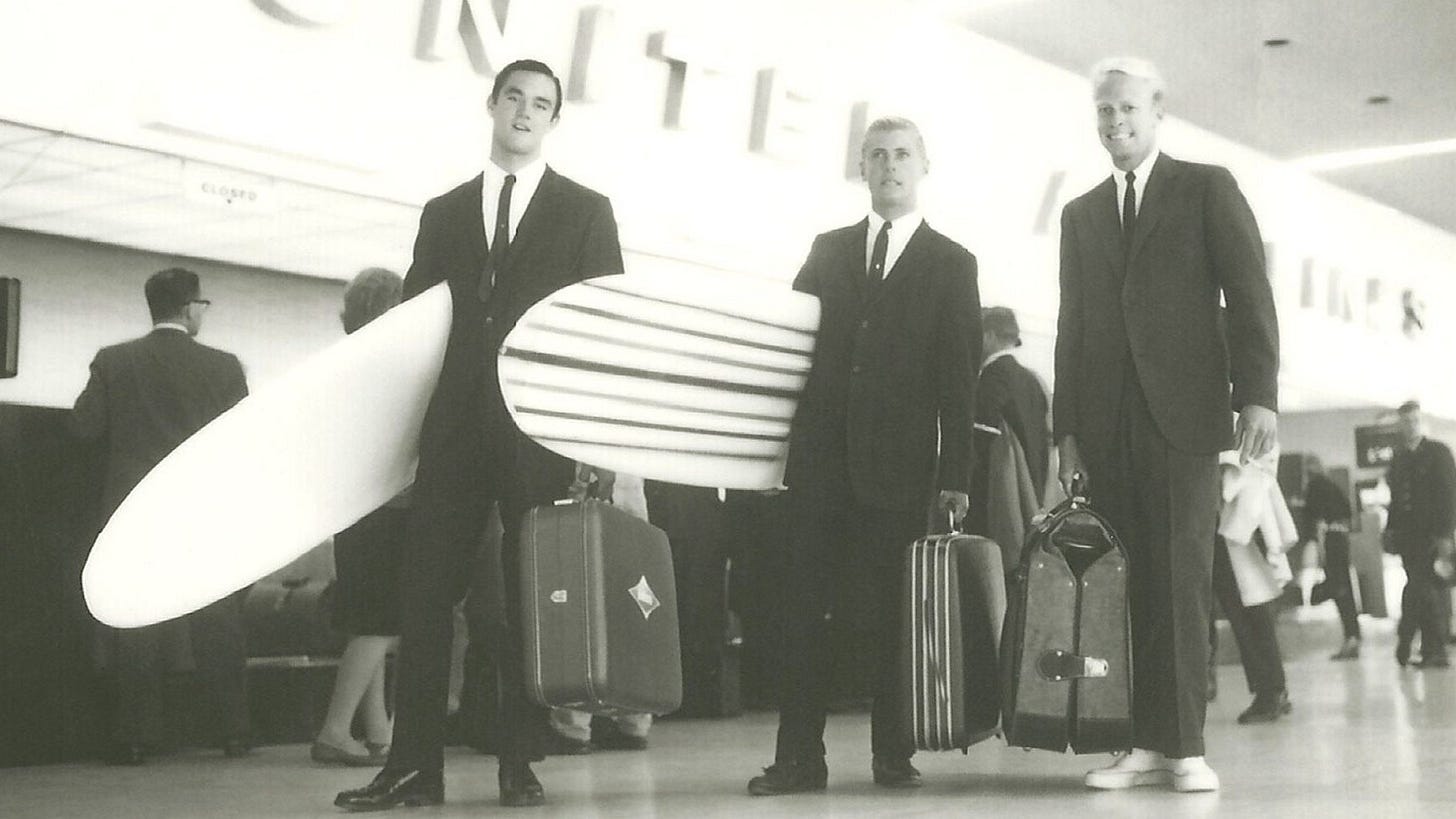 Image may contain Human Person Footwear Clothing Apparel Shoe Coat Overcoat Suit Andr Pops Luggage and Tie