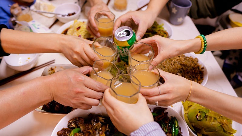 People toast a meal together.