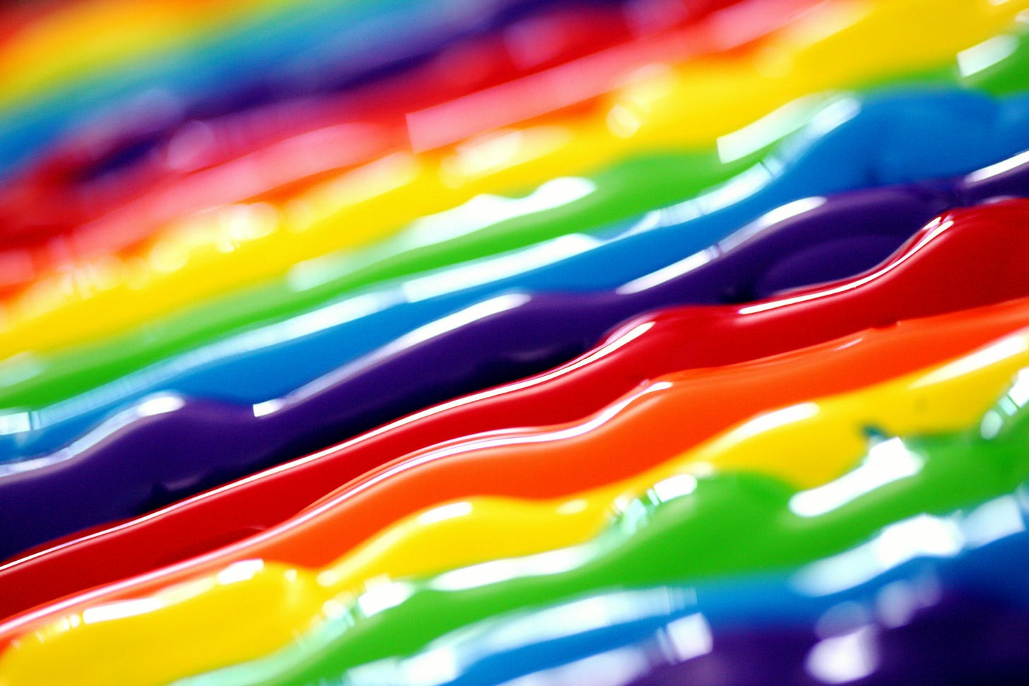 Thick, rainbow paint ribbons, all on a line.