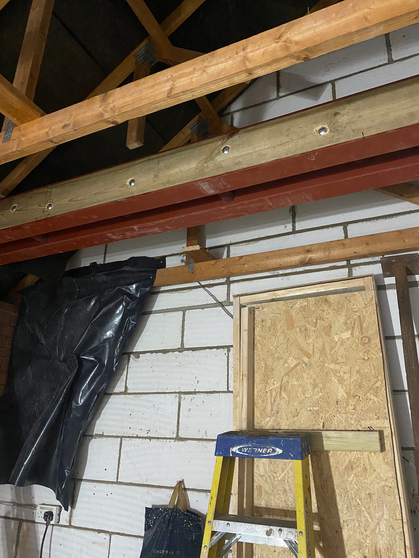 wood panels bolted to the steel beams