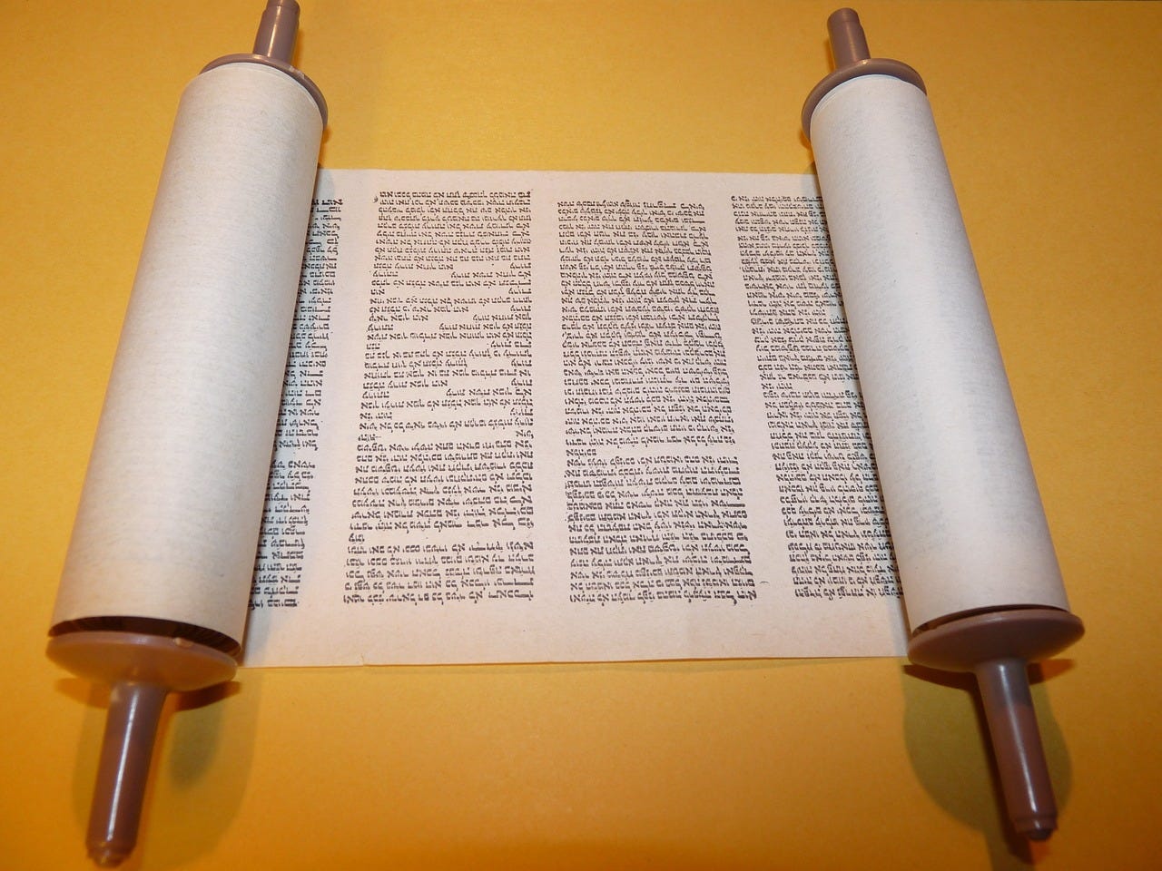 an open torah scroll showing hebrew letters