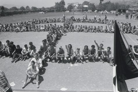 Four images in black and white and color of the Italian Hobbit Camp festival. At least five Celtic crosses are visible across three images. In another image from the festival, dozens of people sit arranged in a giant celtic cross.