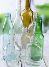 A selection of empty bottles with different coloured glass.