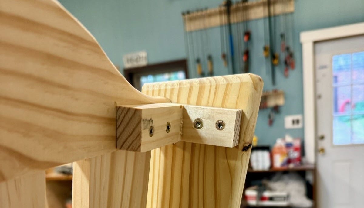 A close up of the back of a porch swing shows support blocks to help keep the back rest from breaking. A close up of the back of a porch swing shows support blocks to help keep the back rest from breaking.