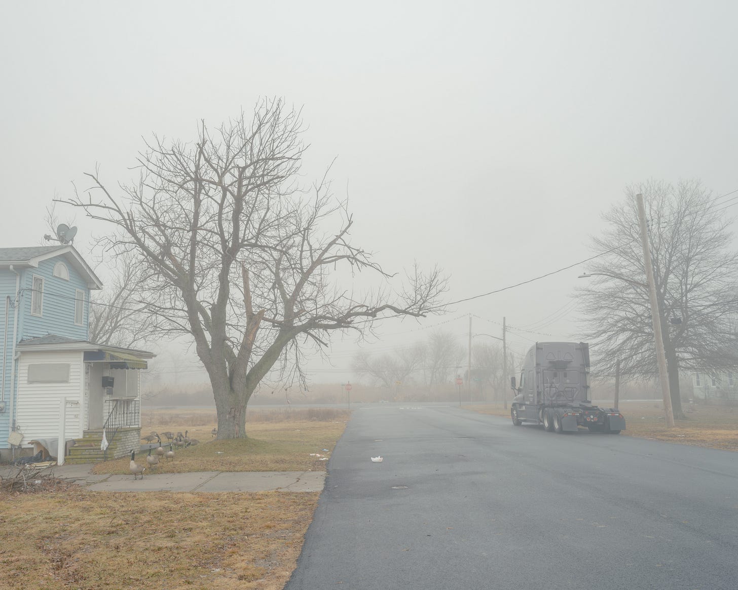 Cab-From-Semi-Truck-On-Foggy-Street-Next-To-House