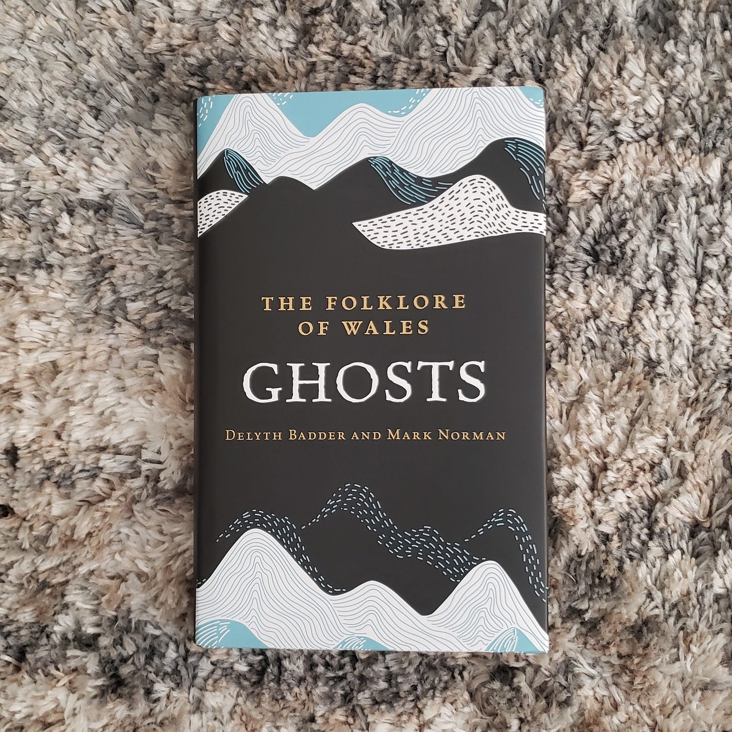 Photo of book, The Folklore of Wales: Ghosts by Delyth Badder and Mark Norman.