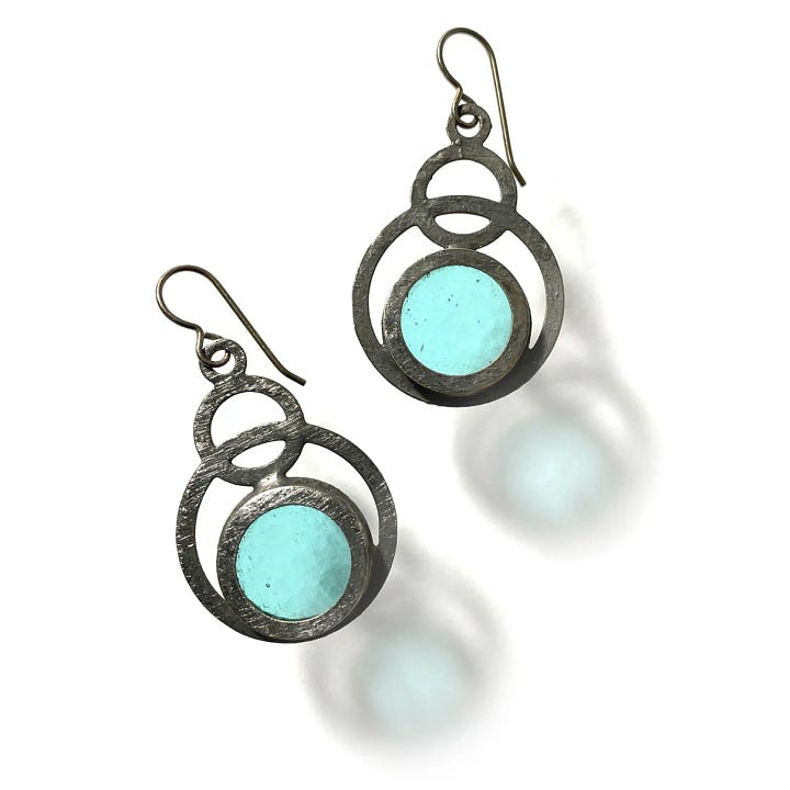 First photo: stained glass earrings with circle motifs.  Second photo: a colorful furoshiki