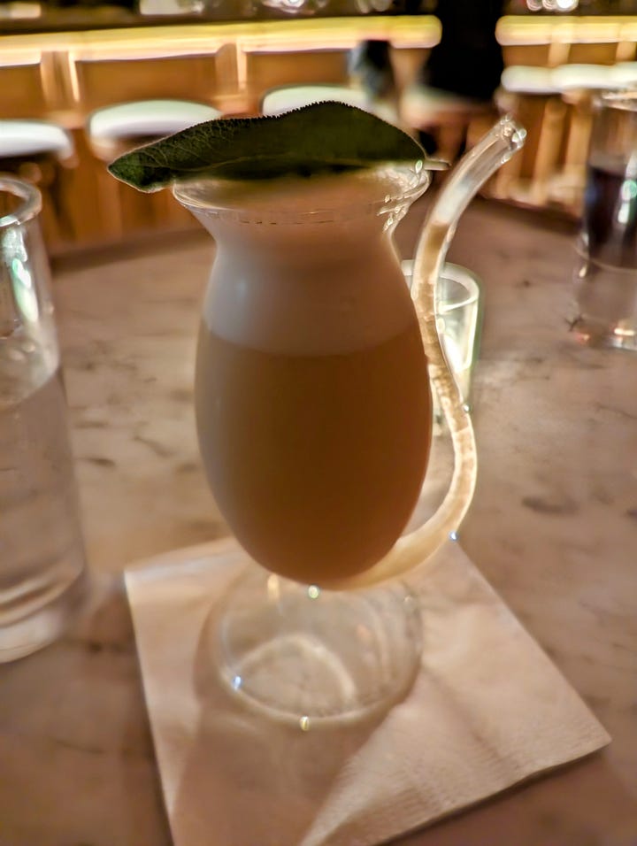 Left: A yellow drink with a sage leaf on top in a glass with a straw tail; Carlos' hand holding a part of his old fashioned, topped with orange peel