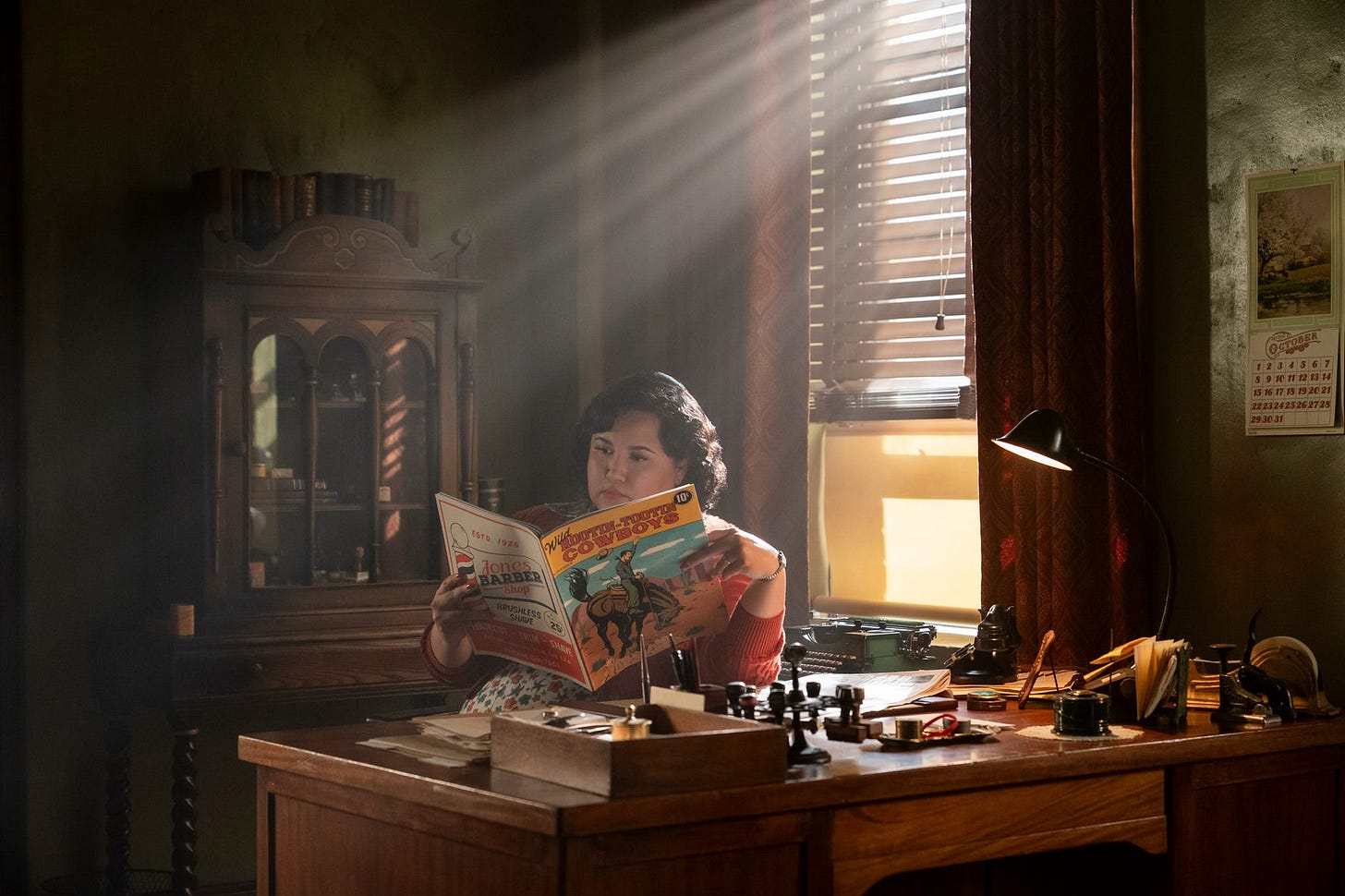 person reading a magazine in a warmly lit room person reading a magazine in a warmly lit room