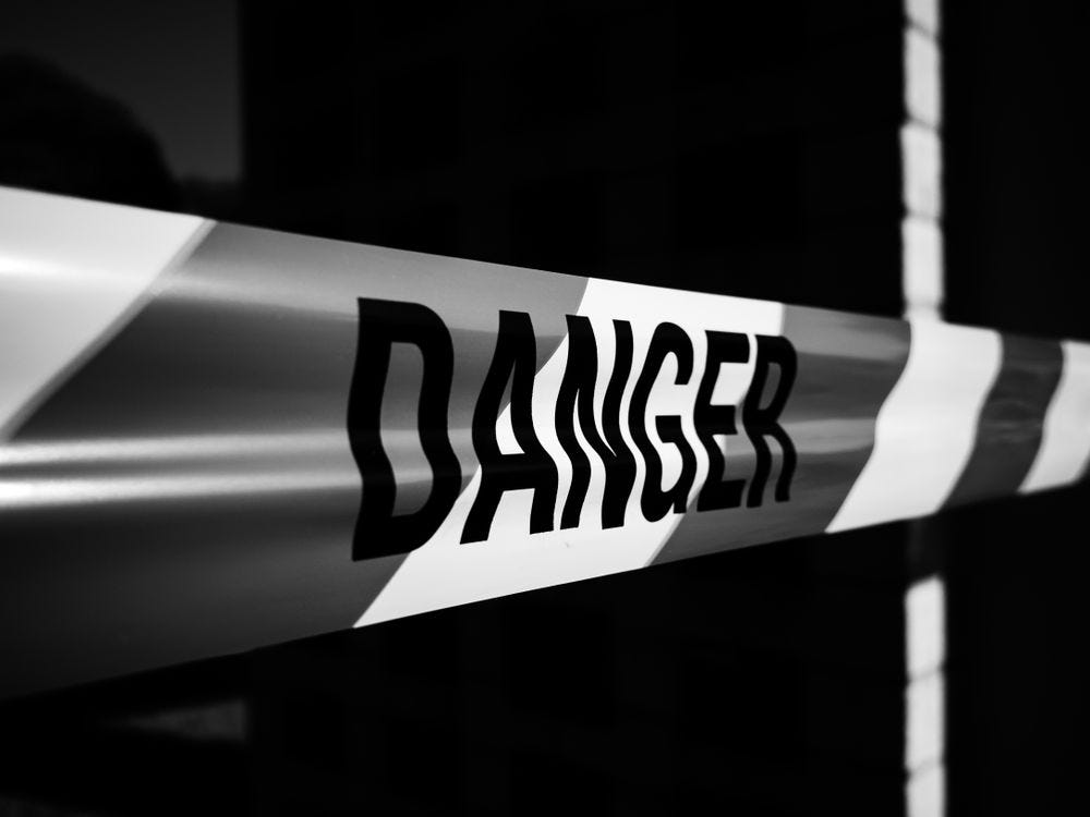 Tape reading "Danger" across a gap