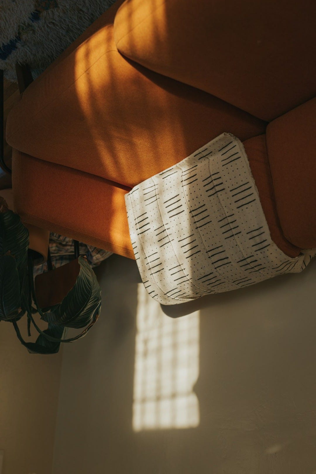 white textile on brown couch