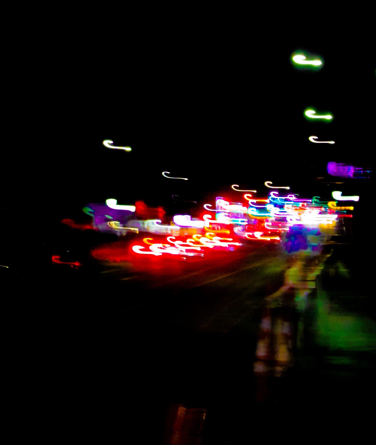 Photo with neon blurred and squiggly lights on black background