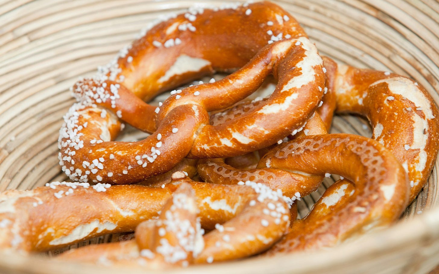 a basket filled with pretzels covered in powdered sugar a basket filled with pretzels covered in powdered sugar