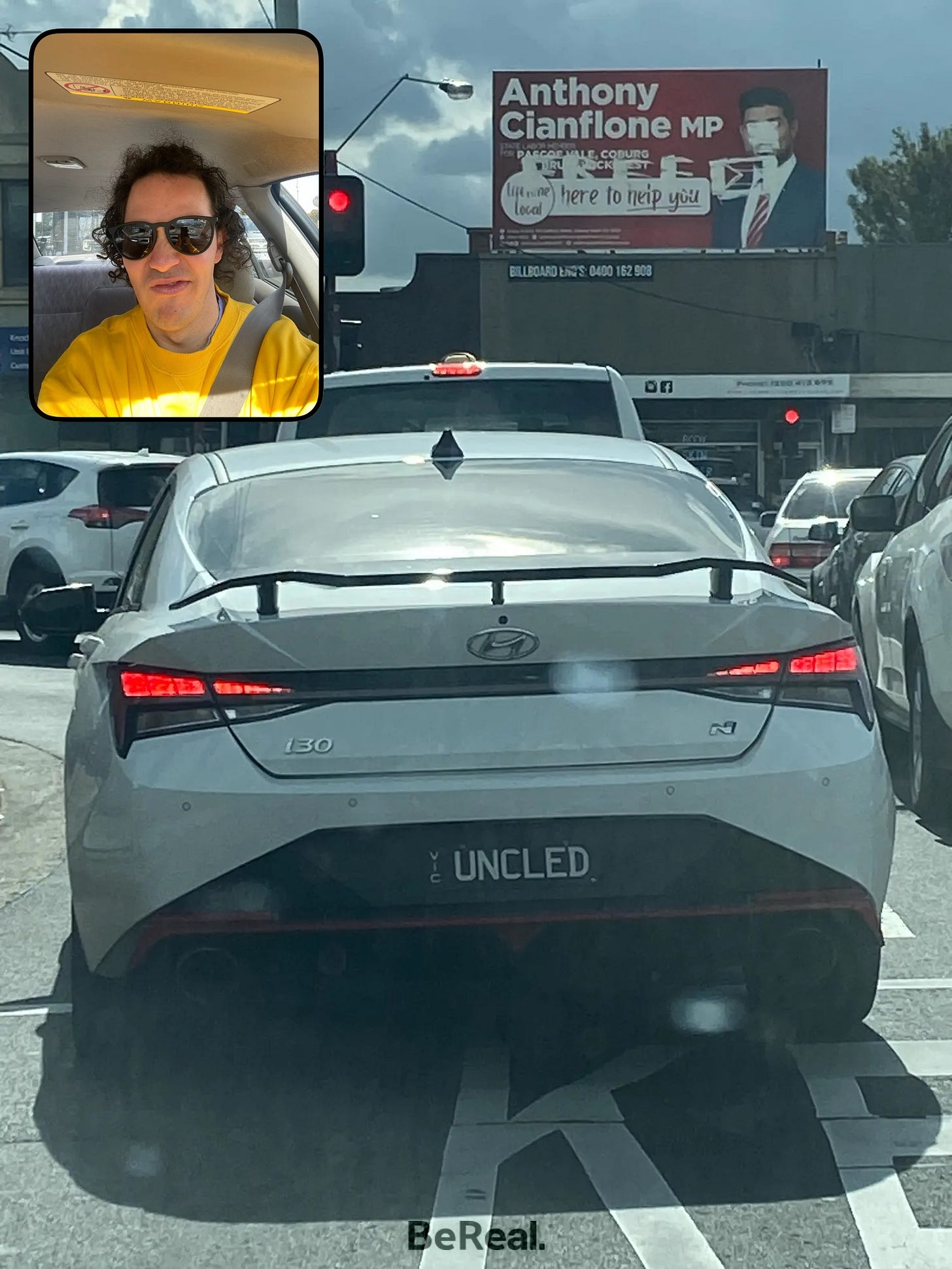 Back end of a white car, Hyundai i30, with the custom number plate: UNCLED