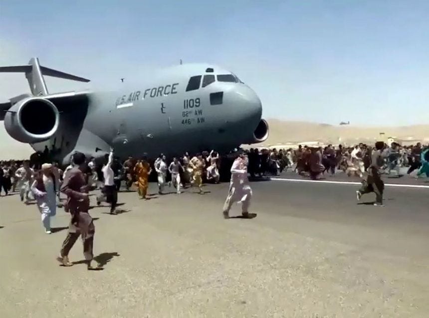 Afghans run alongside a US Air Force transport plane on the runway of the Kabul airport on August 16. Video showed people clinging to the fuselage of the aircraft as it taxied. Afghans run alongside a US Air Force transport plane on the runway of the Kabul airport on August 16. Video showed people clinging to the fuselage of the aircraft as it taxied.