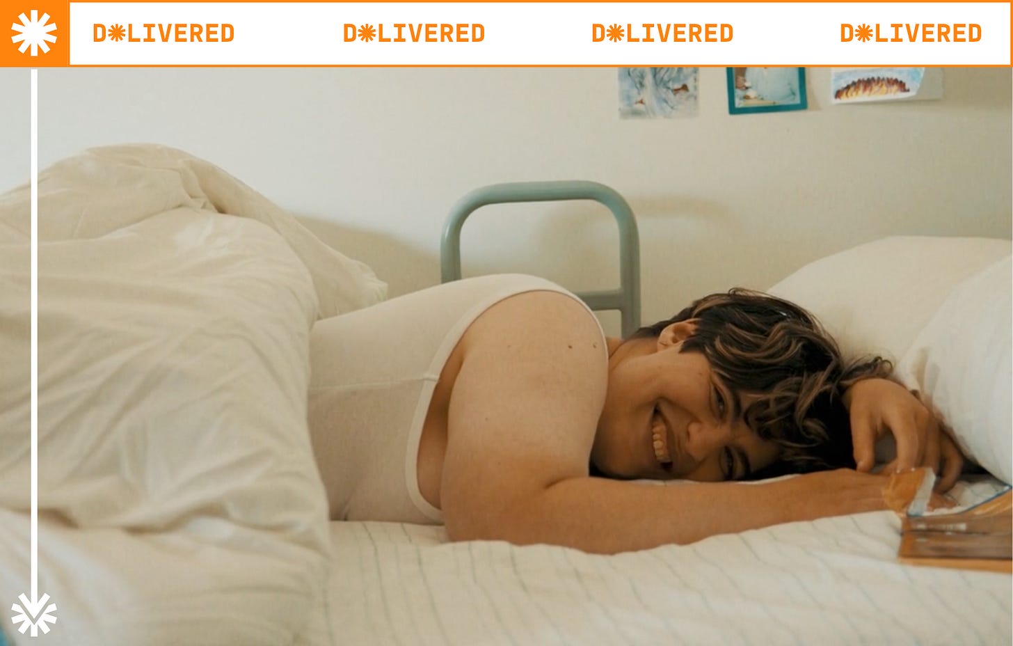 Henrietta Bollinger is a nonbinary person with short hair. They are lying in bed with white linen and smiles at the camera cheekily. Henrietta Bollinger is a nonbinary person with short hair. They are lying in bed with white linen and smiles at the camera cheekily.