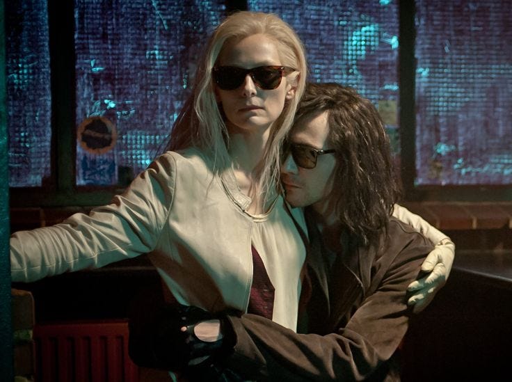 This may contain: two women standing next to each other with the words only lovers left alive