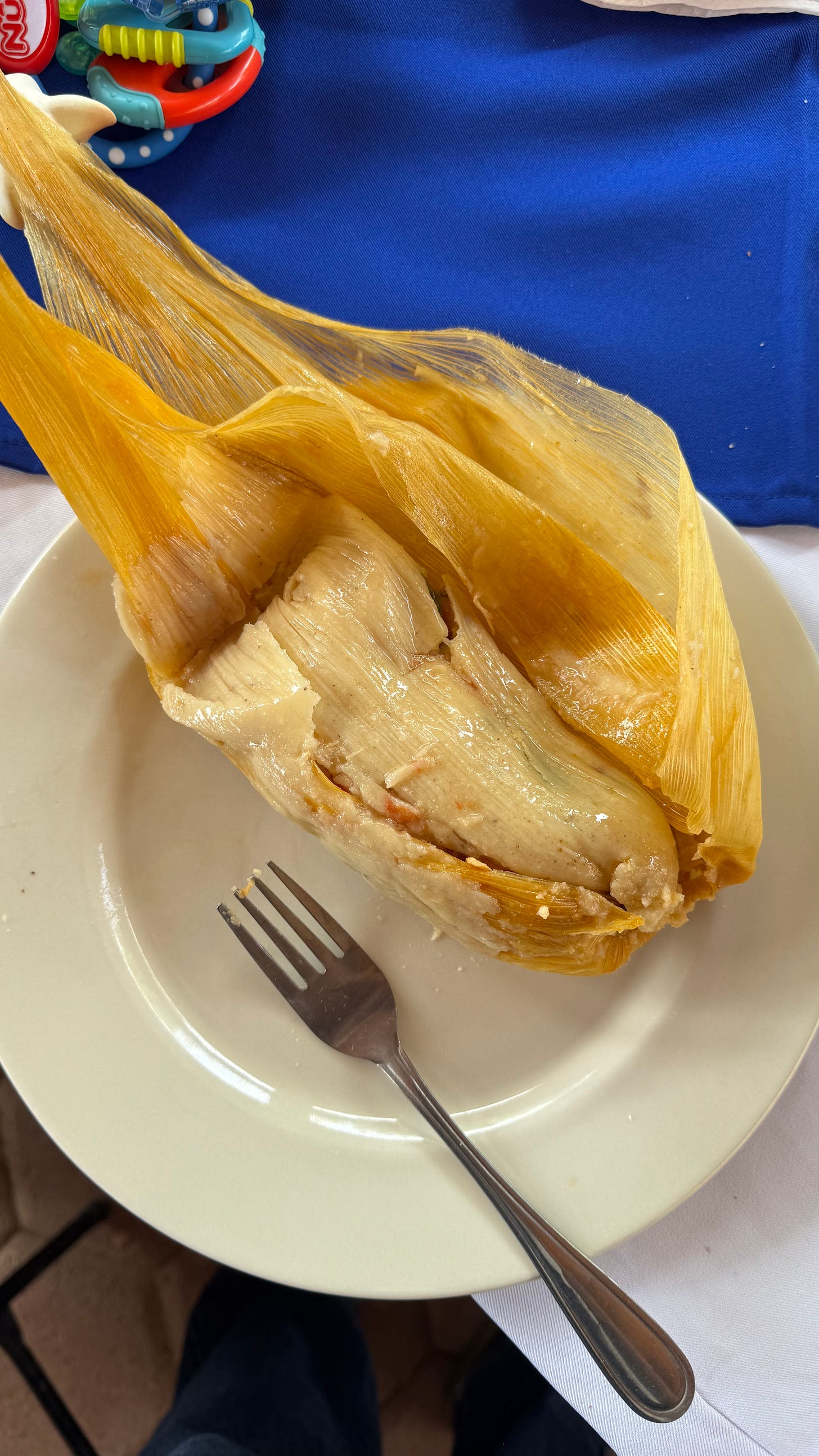 A tamale in a corn husk.