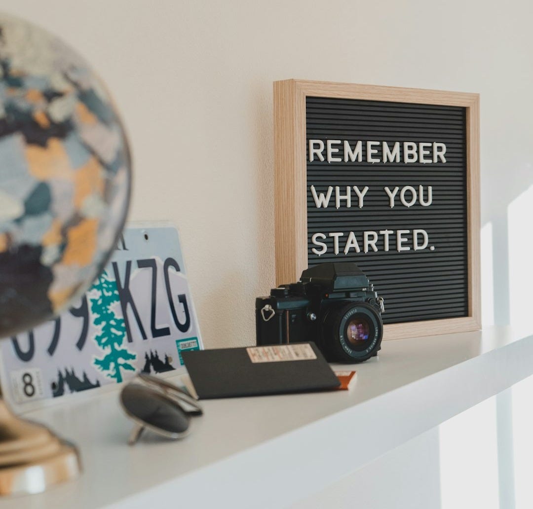shallow focus photo of black SLR camera on white wooden shelf shallow focus photo of black SLR camera on white wooden shelf