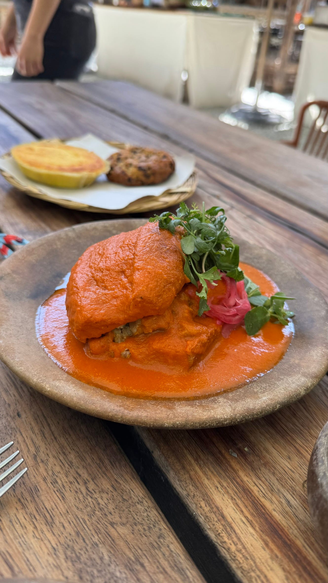 A sandwich covered in sauce.