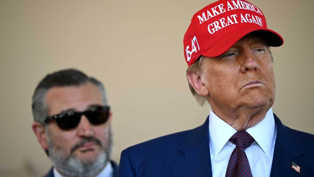 A photo of U.S. President-elect Donald Trump wearing a red "Make America Great Again" cap. Senator Ted Cruz is standing to Trump's right, wearing sunglasses. A photo of U.S. President-elect Donald Trump wearing a red "Make America Great Again" cap. Senator Ted Cruz is standing to Trump's right, wearing sunglasses.