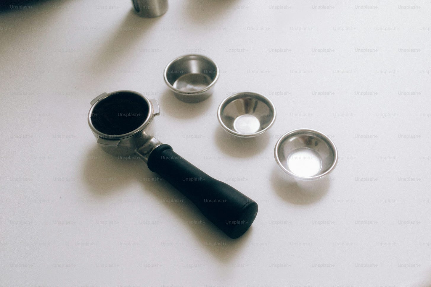 Espresso portafilter with three metal dosing cups Espresso portafilter with three metal dosing cups