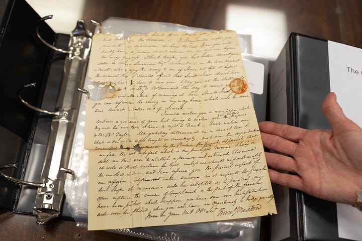 A letter from the collection; Aaron D. Purcell, director of University Libraries Special Collections and University Archives looks through the letters with Sue Heth Bell. Photo by Case Parker for Virginia Tech.