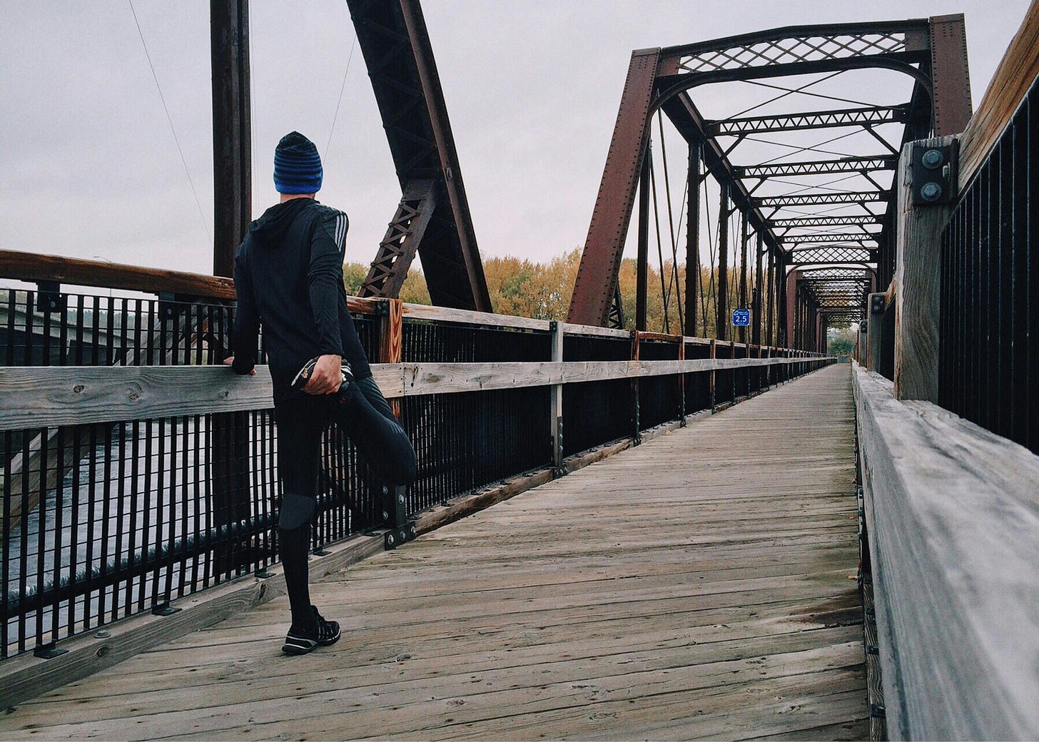 Man Standing on Bridge Ready to Run