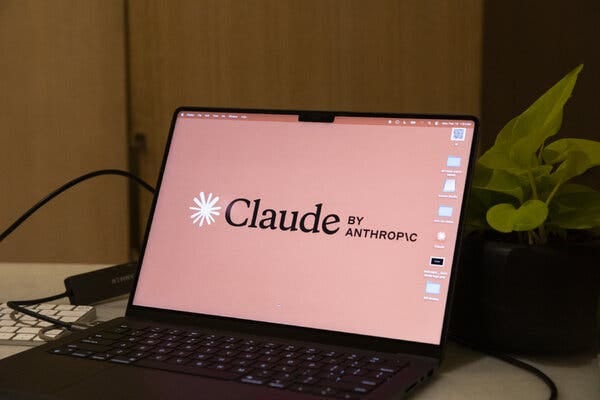 A laptop computer is opened to the Claude screen.