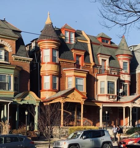 large older home with turret and a paint job