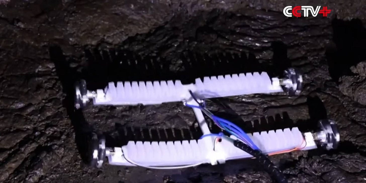 A flexible four-wheeled robot navigates the cave environment.
