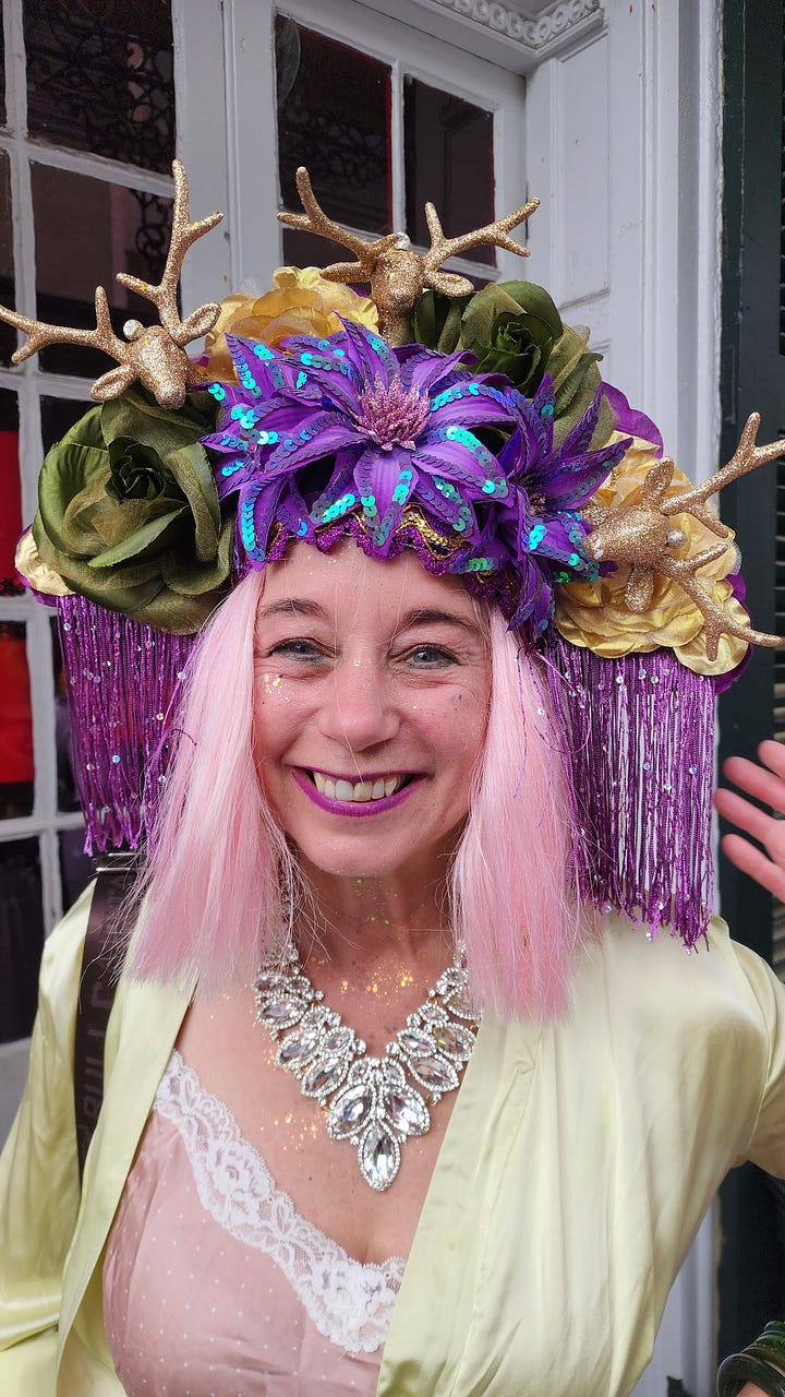 A woman in a pink wig, a weird hat, and pajamas