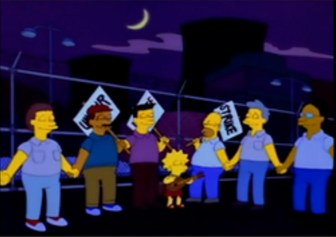 A still from the Simpsons episode ‘Last exit to Springfield’ Lisa, Homer and a group of striking workers hold hands outside the power plant.