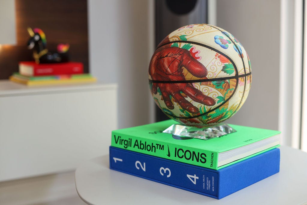 At the back: Good Luck Charm, 2021 mixed media Edition AP5/12; and basketball in the front: Kehinde Wiley, Death of St Joseph basketball. Courtesy of Chris Lyons At the back: Good Luck Charm, 2021 mixed media Edition AP5/12; and basketball in the front: Kehinde Wiley, Death of St Joseph basketball. Courtesy of Chris Lyons