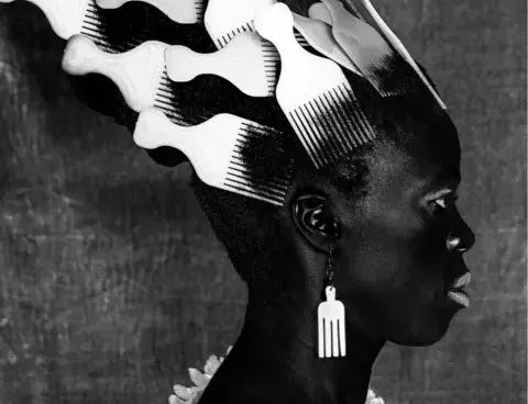 Zanele Muholi Person wearing afro combs in their hair and as earrings.