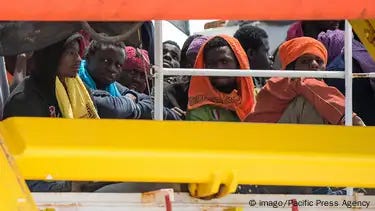 Sub-Saharan migrants rescued in the Mediterranean Sea are seen waiting onboard the rescue ship Dignity, run by Doctors Without Borders (MSF) Sub-Saharan migrants rescued in the Mediterranean Sea are seen waiting onboard the rescue ship Dignity, run by Doctors Without Borders (MSF)