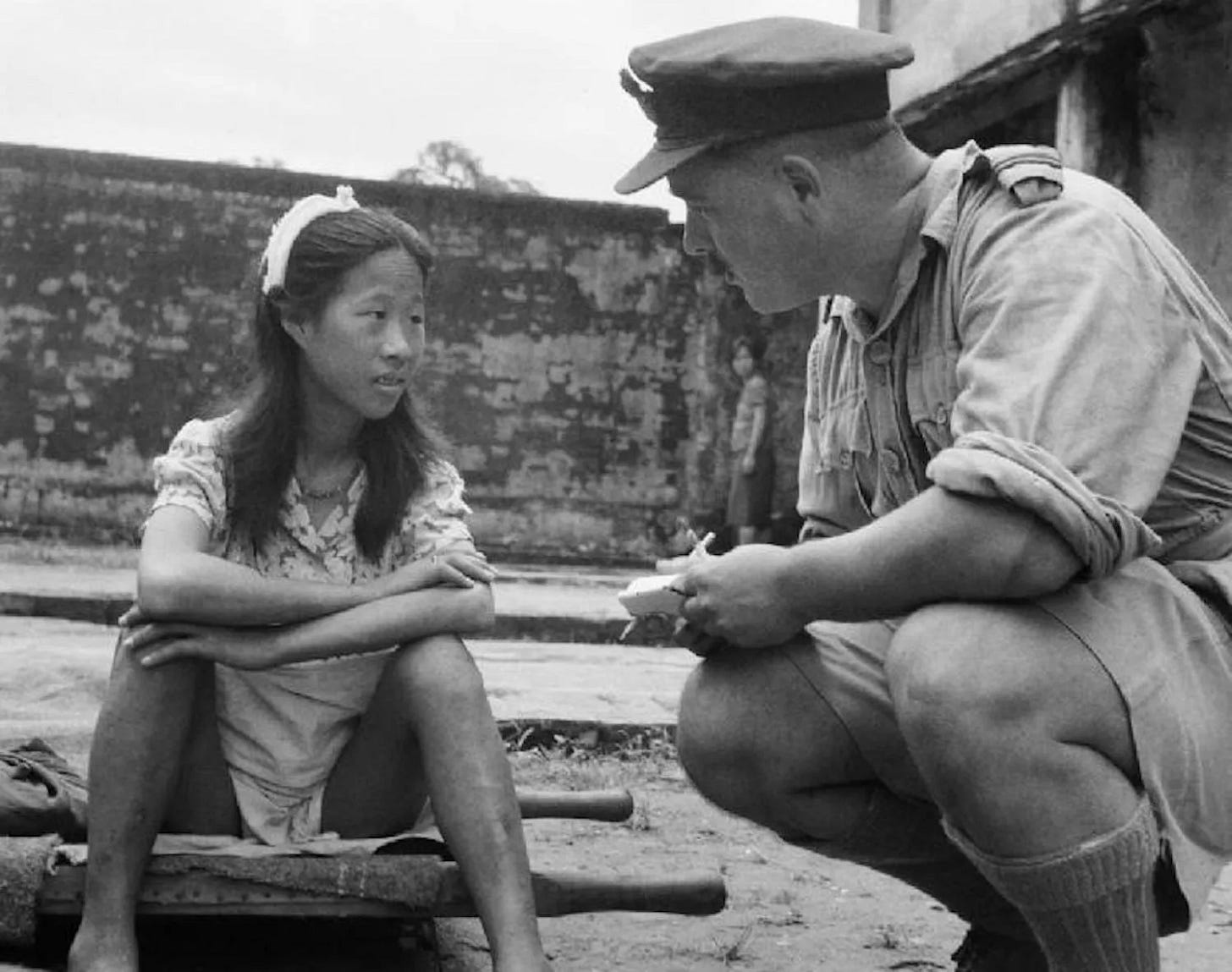 A young Chinese comfort woman being interviewed by an allied officer in Rangoon, Burma. August 8, 1945.