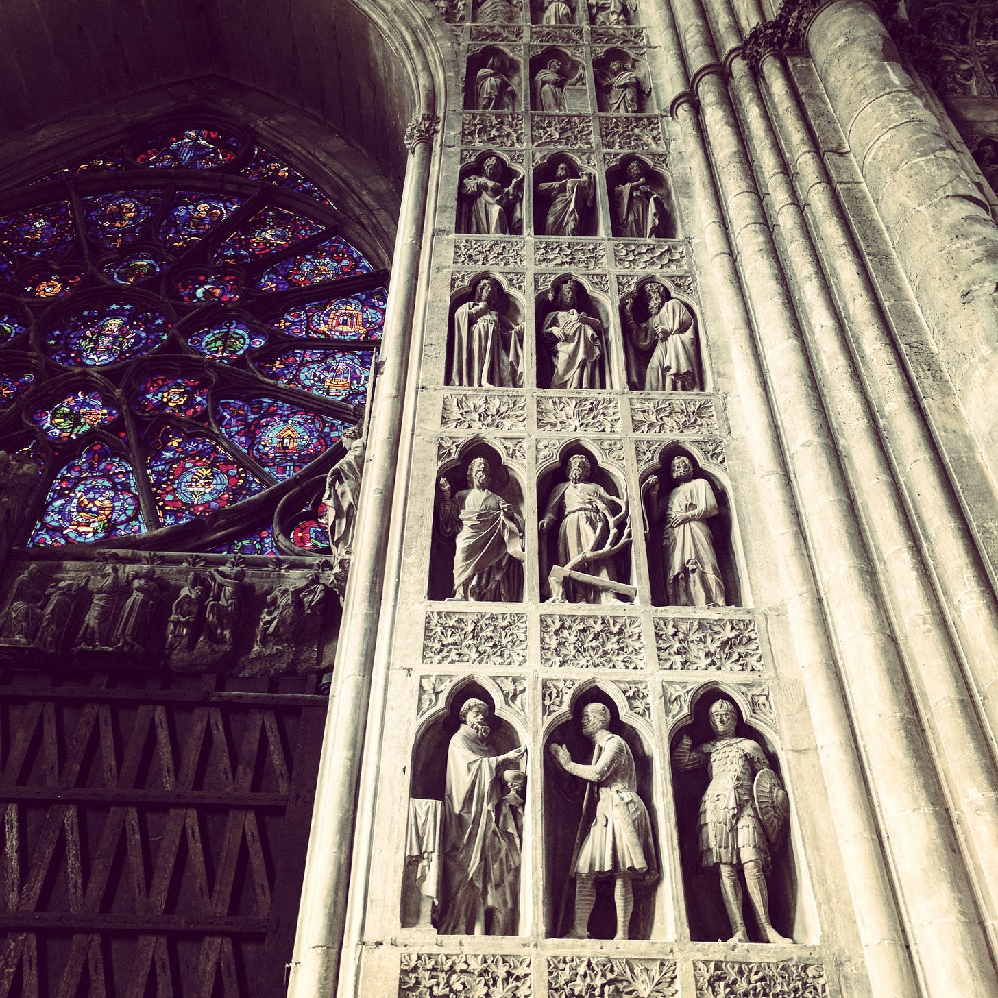 Inside the cathedral at Rheims, with a rose window and scultpures