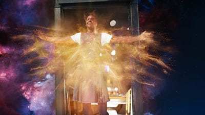 The Doctor stands at the door of the TARDIS in space, regenerating