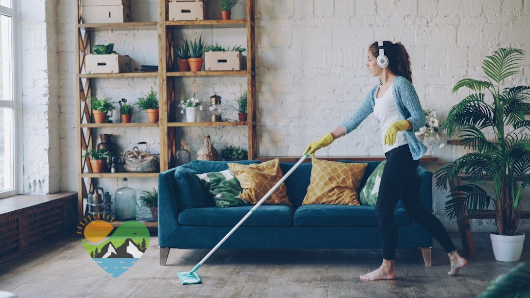 Woman with headphones mopping a wooden floor