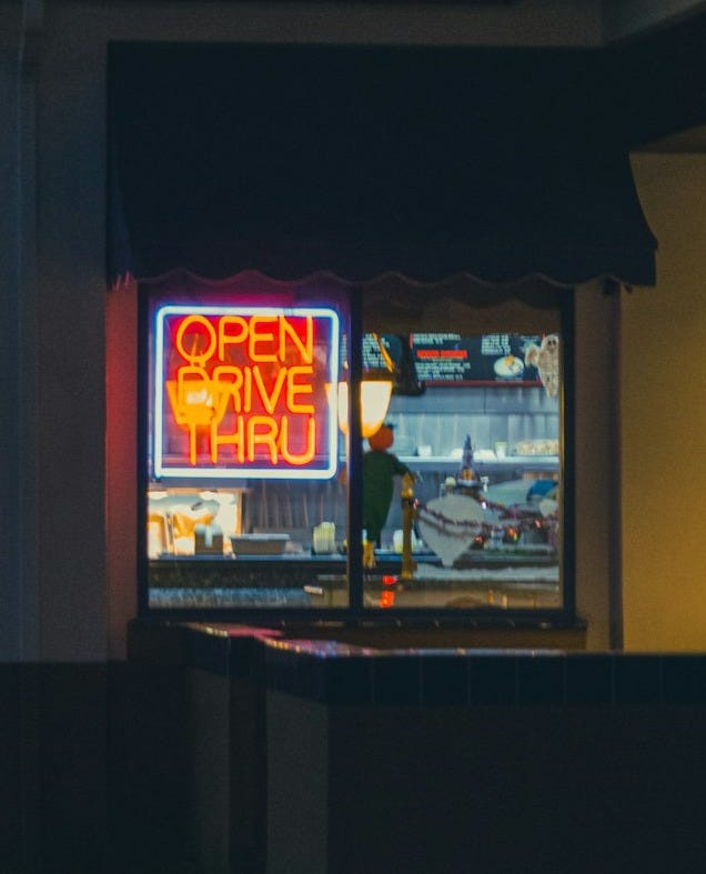 a store front at night with a neon sign