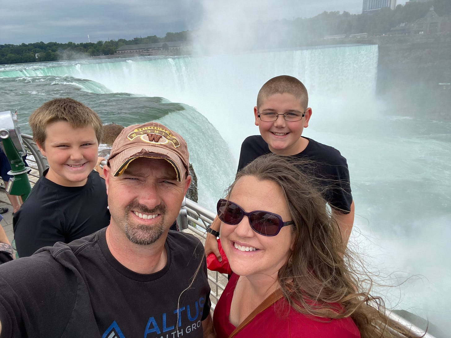 Parents and two homeschooling boys in front of Niagara Falls)