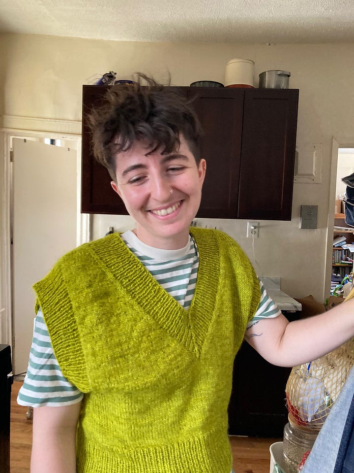 First image is a photo of myself in a lime green vest. Second is a needlepoint of a lemon on a plate. the tip has been cut off. the resulting tip looks like a nipple