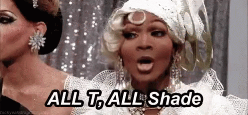 a drag queen is saying `` all t , all shade '' while wearing a white dress . a drag queen is saying `` all t , all shade '' while wearing a white dress .