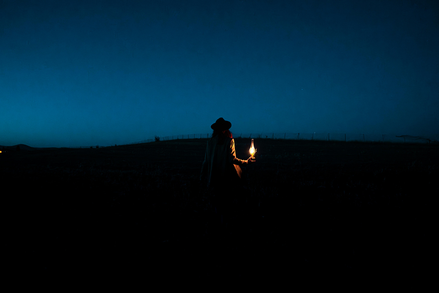 A person holding a candle in the dark
