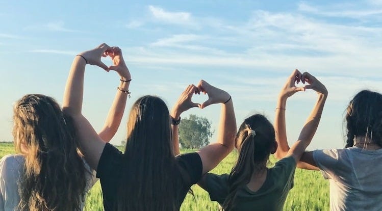 women forming heart gestures during daytime women forming heart gestures during daytime