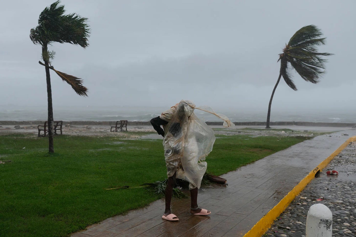 A man walks through the wind&nbsp;as Hurricane Melissa approaches in Kingston, Jamaica on Oct. 28.