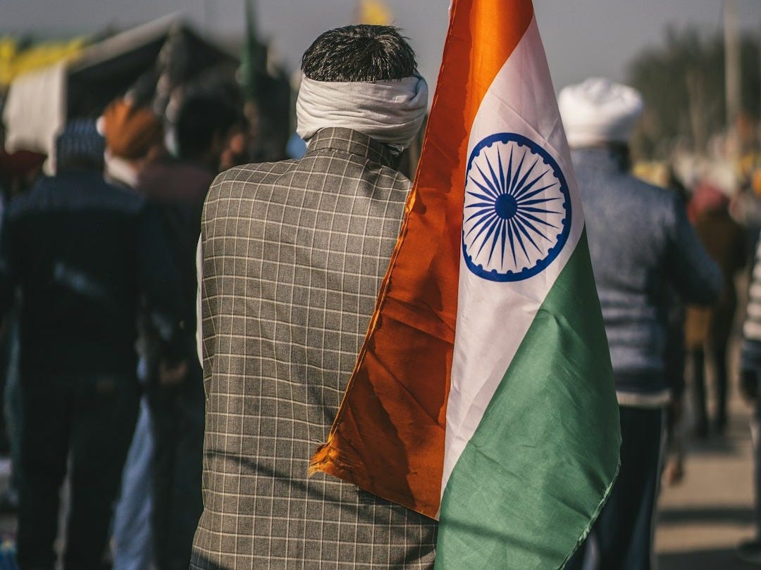 a man is holding a flag in his hand a man is holding a flag in his hand